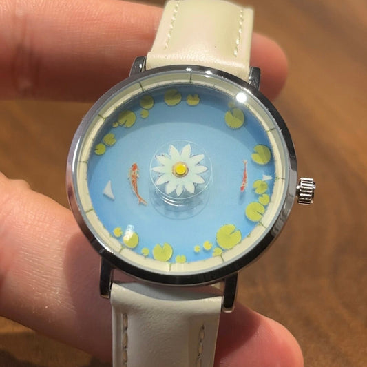 Aqua Animism blue koi and lotus dial shown on the wrist