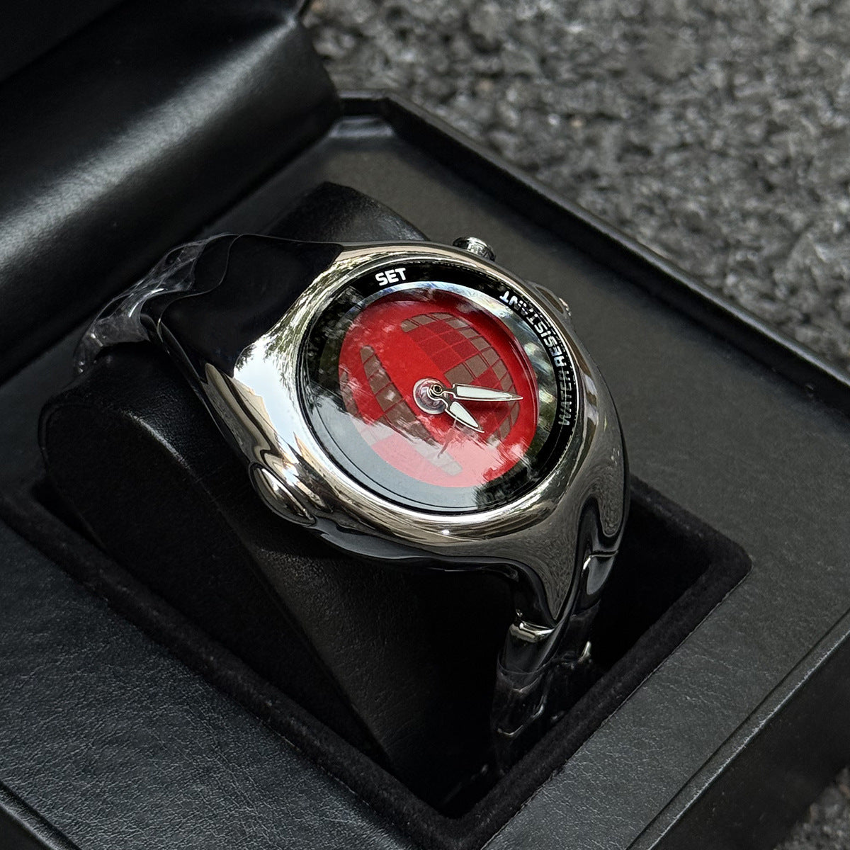 Morph Drift red dial sculpted metal watch displayed in a black box