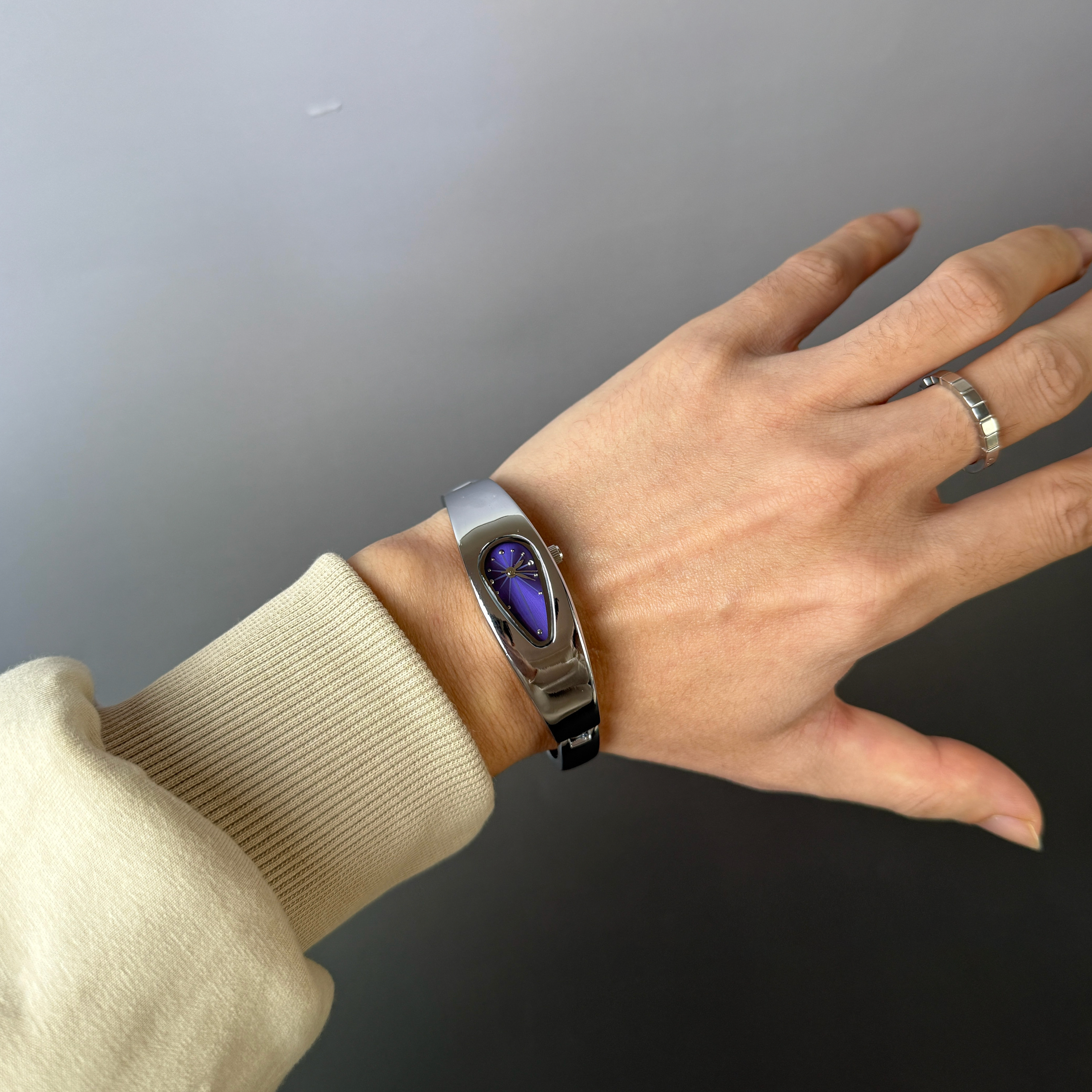 Mercury Drop black dial Y2K futuristic waterdrop watch worn on wrist