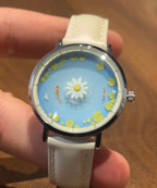 Aqua Animism blue koi and lotus dial shown on the wrist
