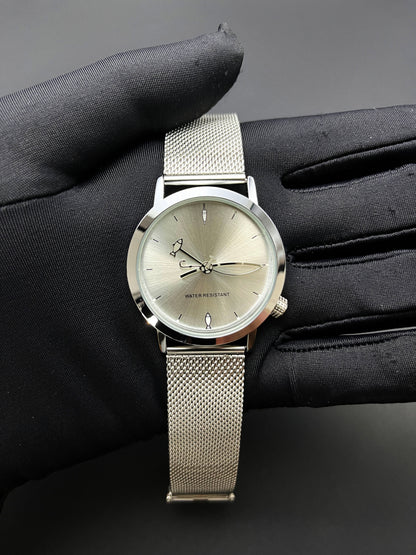 CHOOSZ Lucky Cast watch held in a black-gloved hand, showing sunburst dial, fishing-themed hands and silver mesh strap