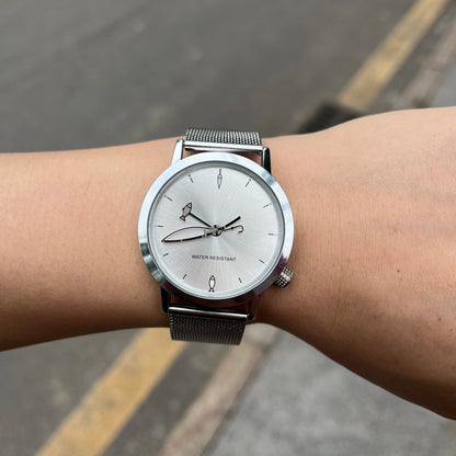CHOOSZ Lucky Cast watch worn outdoors, showing its silver fishing-themed dial and stainless steel mesh strap