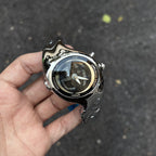 Morph Drift black dial sculpted metal watch held outdoors