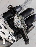 Temporal Distortion silver surrealist asymmetrical watch displayed with accessories