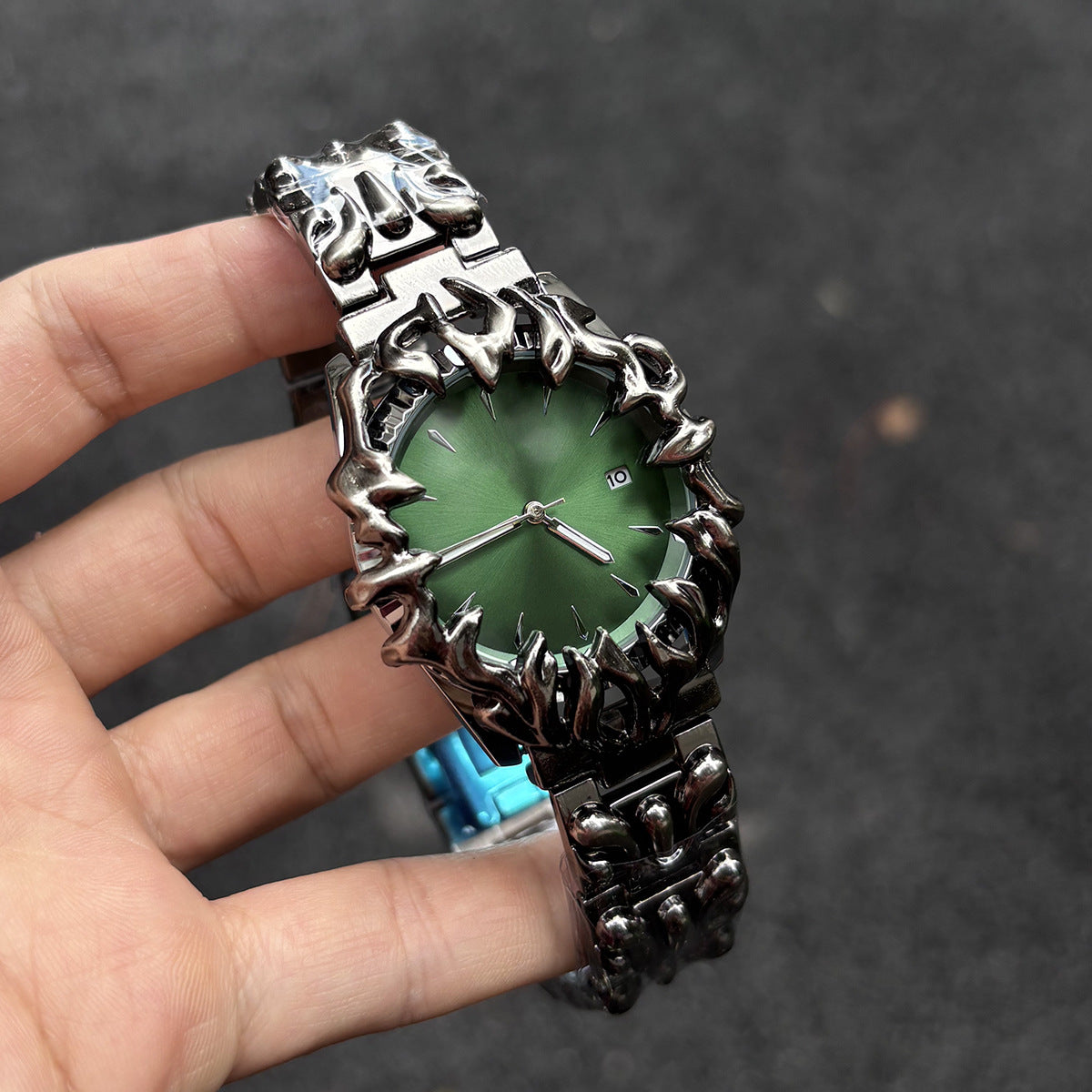 Abyssal Vine green dial gothic sculpted metal watch handheld close-up