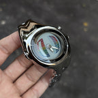 Morph Drift multicolor dial sculpted metal watch held outdoors