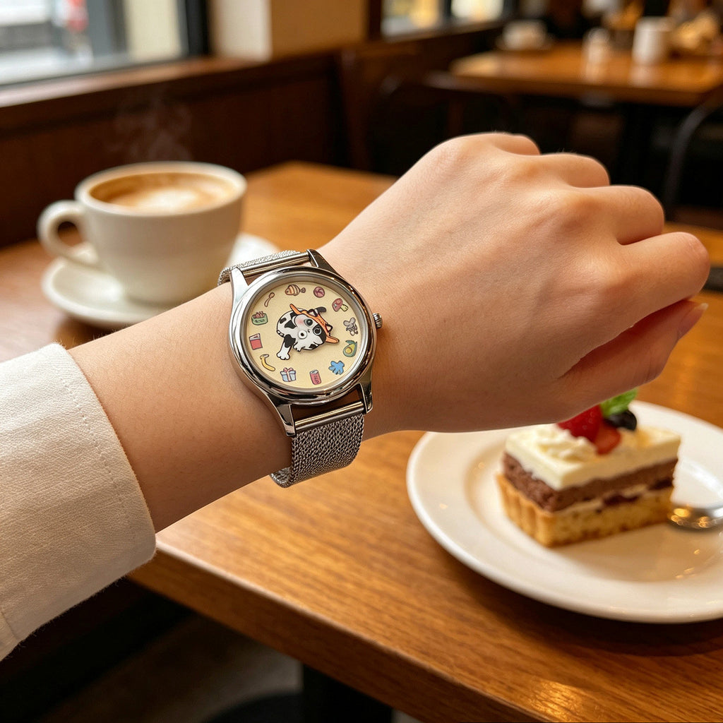Meow's Wishlist Tuxedo Cat watch with silver mesh strap worn in a café