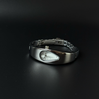 Mercury Drop bracelet watch with silver teardrop dial and polished silver-tone case on a dark surface, angled view