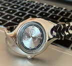 Chrono Flux silver Y2K futuristic analog watch displayed on desk