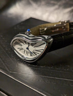 Temporal Distortion gold surrealist asymmetrical watch angled close-up