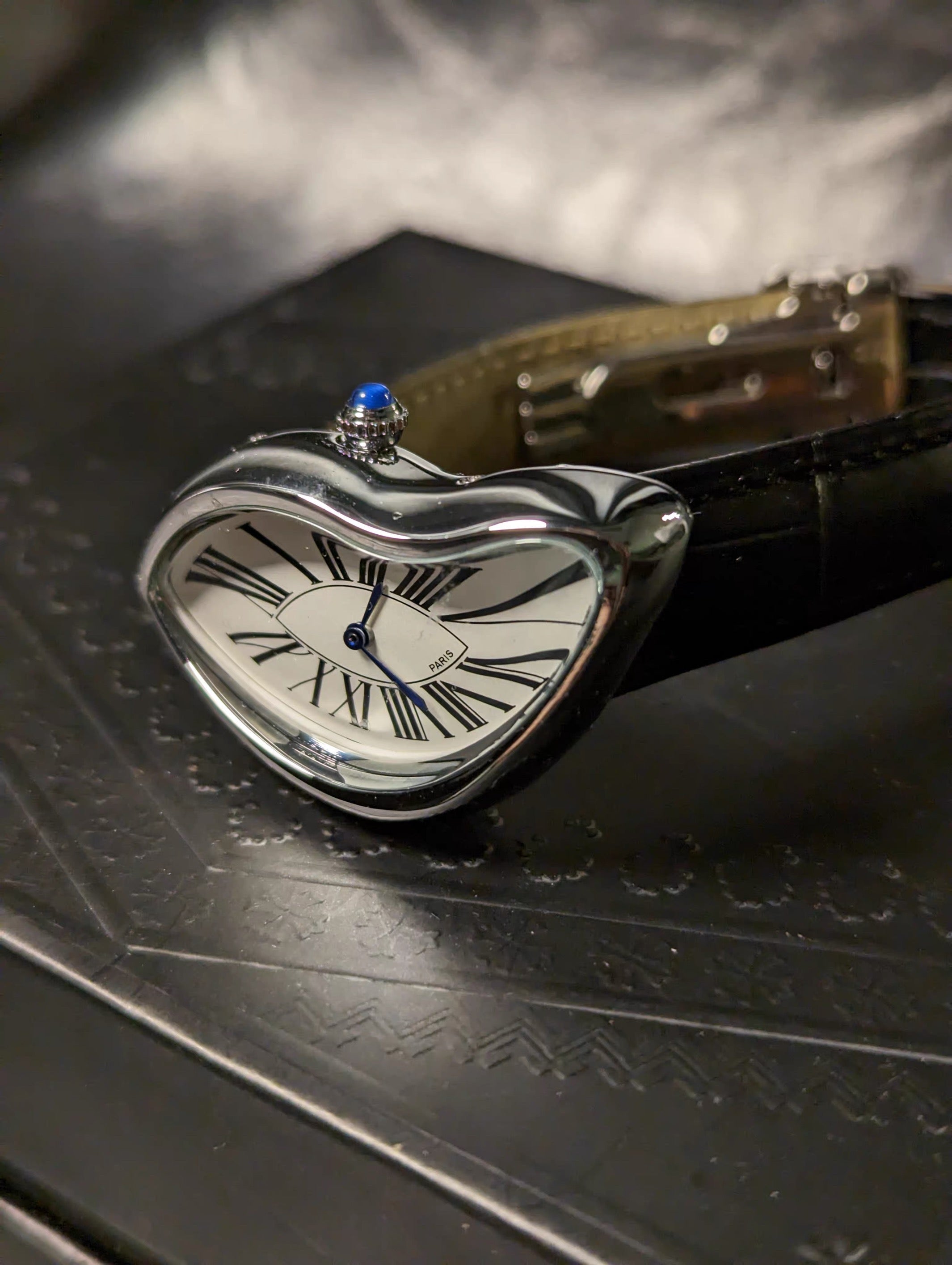Temporal Distortion gold surrealist asymmetrical watch angled close-up