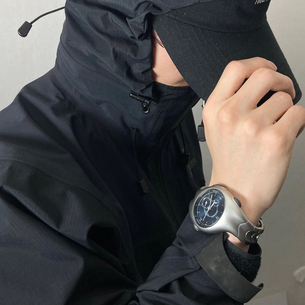 Chrono Flux black Y2K futuristic analog watch worn on wrist