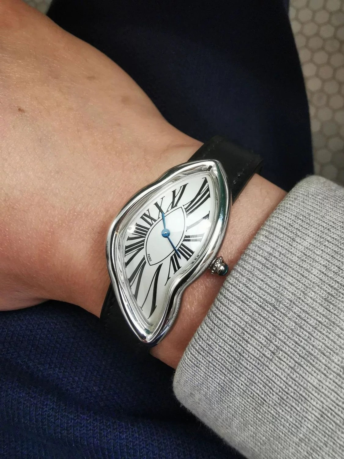 Temporal Distortion silver surrealist asymmetrical watch worn on wrist