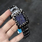Abyss Grip purple dial gothic skeleton claw watch handheld close-up