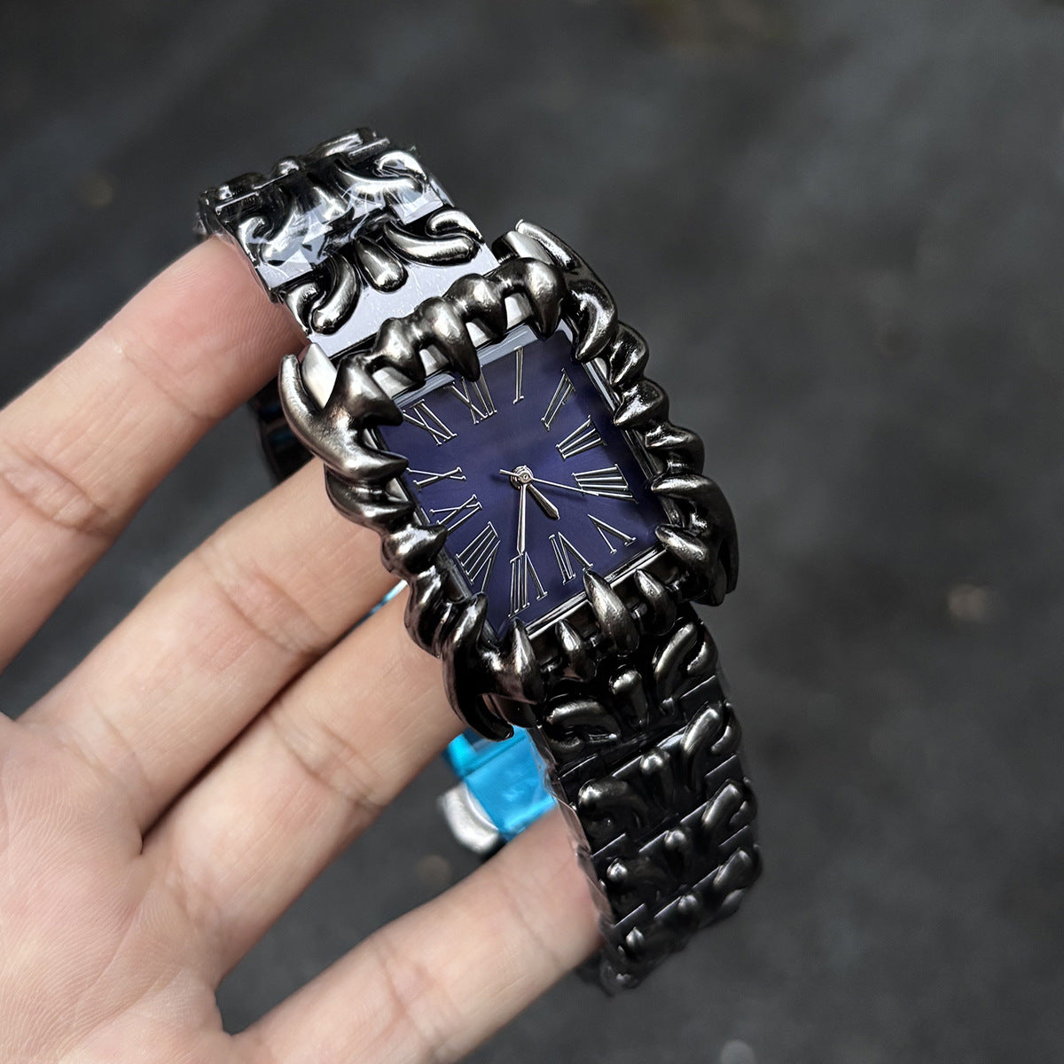 Abyss Grip purple dial gothic skeleton claw watch handheld close-up