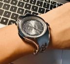 Chrono Flux silver Y2K futuristic analog watch worn on wrist close-up