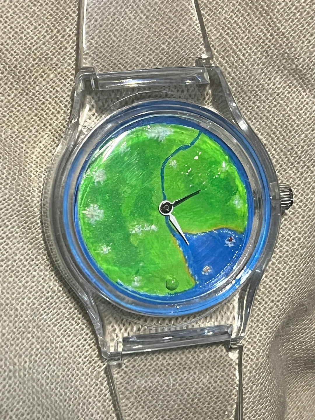 Nature's Orbit development study with transparent case and bright green landscape