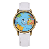 CHOOSZ Wander Orbit watch with blue world-map dial, airplane-shaped seconds hand, antique gold-tone case and white textured strap