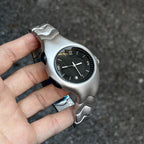 Chrome Ripple black wavy metal watch dial close-up