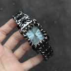 Abyss Grip blue dial gothic skeleton claw watch handheld close-up