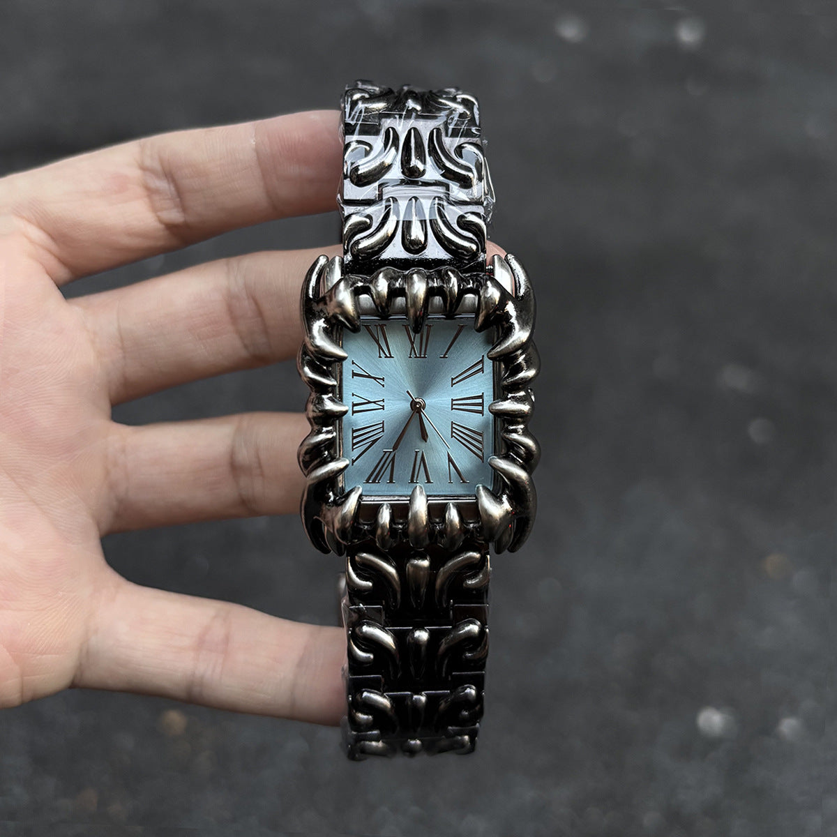 Abyss Grip blue dial gothic skeleton claw watch handheld alternate angle