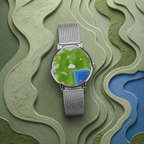 Nature's Orbit watch with silver mesh strap on layered green topographic background