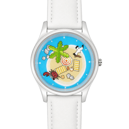 Close-up of Lazy Island Diary watch with white strap, showing palm tree, beach umbrella, red crab and seagull on the dial