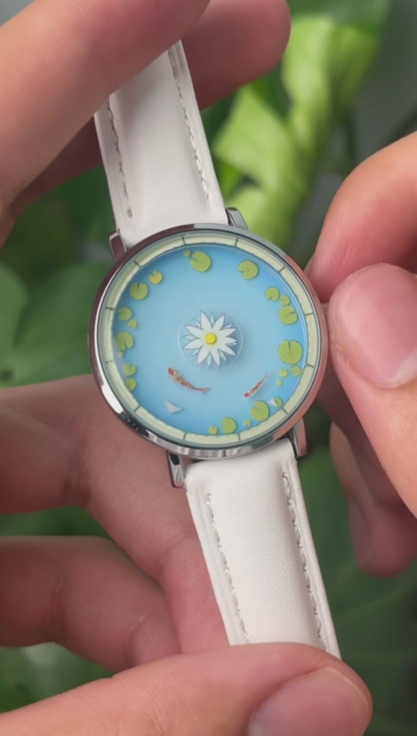Aqua Animism watch video demonstrating the larger hour koi and smaller minute koi circling the lotus dial