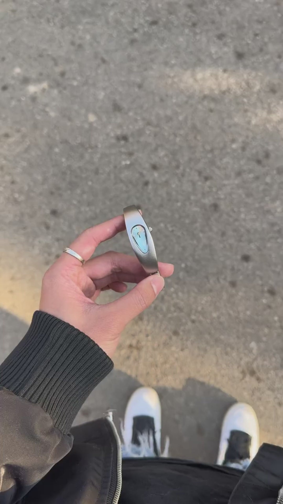 Mercury Drop Blue watch video showing the teardrop dial and sculptural metal case in outdoor sunlight