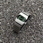 Exoskeleton Link matte silver Y2K futuristic analog watch displayed on gravel