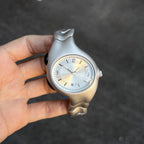 Chrome Ripple silver wavy metal watch dial close-up