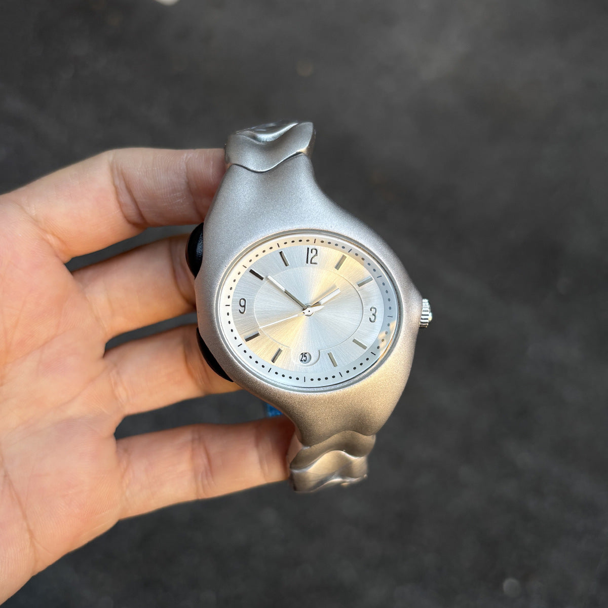 Chrome Ripple silver wavy metal watch dial close-up