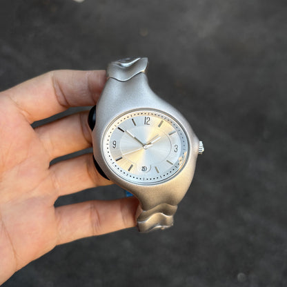 Chrome Ripple silver wavy metal watch dial close-up