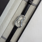 Fluid Mirage silver surrealist melted silhouette watch displayed on railing
